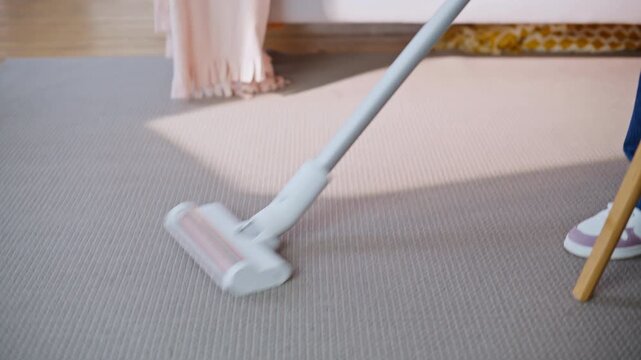 Father daughter cleaning house weekend morning. Preteen girl vacuuming carpet