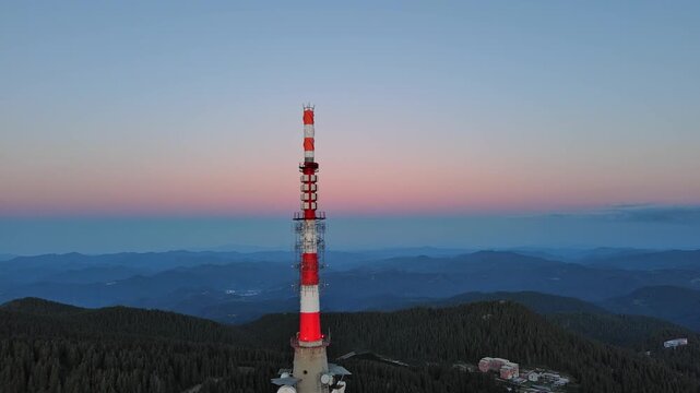 Tower Snezhana on peak of Snezhana covered with spruce forests in Rhodope mountains