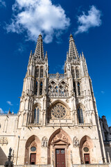 Fototapeta premium Burgos Cathedral facade against a bright blue sky in Spain
