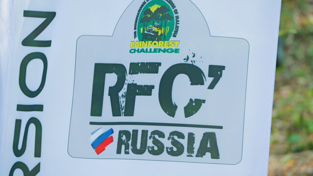 Close-up of a rugged decal for an extreme 4x4 race. The graphic features a distressed logo, Russian flag, and text for a jungle competition. The background is blurred nature. Russia, November 27, 2024