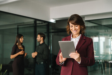 Executive woman in suit working using computer for finance business banking work. Smiling...