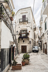 View through narrow, winding alleys of Vieste in Apulia on the Gargano peninsula, southern Italy, with Mediterranean atmosphere, historic architecture and coastal town charm.