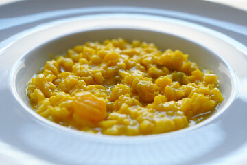 Closeup of pumpkin risotto on white background 