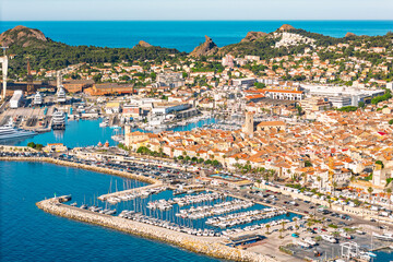 Aerial drone view of La Ciotat marina with yachts and harbor infrastructure along the Mediterranean coast of southern France