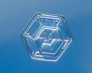 Natural snowflake crystal in blue background