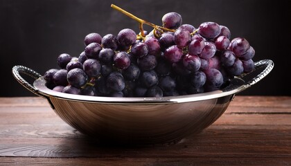 Dark Purple Grapes In A Modern Metallic Bowl On A Wooden Surface