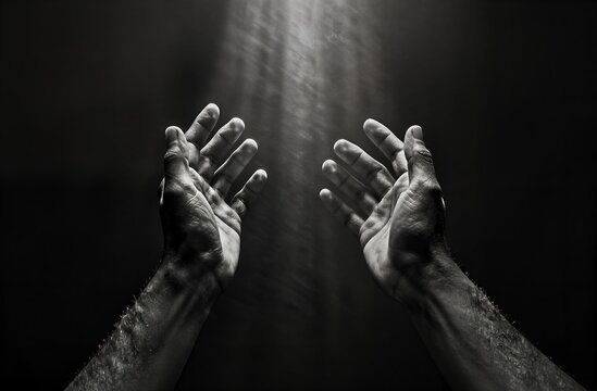 Hands reaching up receiving spiritual light from above