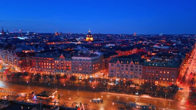 Streets of modern Stockholm, Sweden are beautifully illuminated in the evening. Approaching historical architecture in the city center.