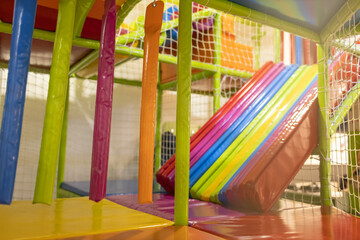 Colorful indoor play area with slides and climbing structures for children at a fun center
