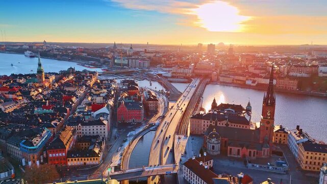 Bright setting sun lights the beautiful cityscape of Stockholm, Sweden. Historical architecture of stunning city from drone.