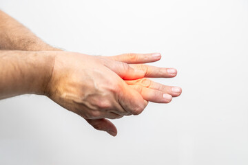 Hand pain, close-up of male hands on a white background
