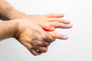 Hand pain, close-up of male hands on a white background
