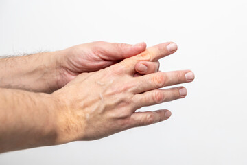 Hand pain, close-up of male hands on a white background
