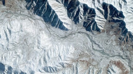 Aerial view of snow covered mountains and agricultural land