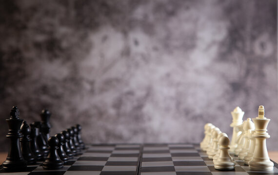chess board with chess pieces and chess board on dark background. business strategy and strategy concept