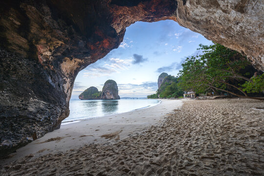 sunrise from a cave on railay beach, princess cave in krabi in thailand