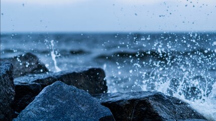 sedition. Ocean waves crashing against dark rocks with splashing water droplets in dramatic seascape. travel magazines, destination branding, designed for outdoor magazines and nature guides.
