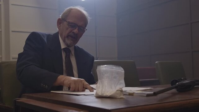 Criminal Trial lawyer in court pointing to notes - modern court room scene