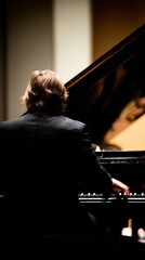 pianist. A pianist at a grand piano, highlighted by dramatic lighting in a concert setting. event programs, museum guides, designed for cultural heritage projects and event programs.
