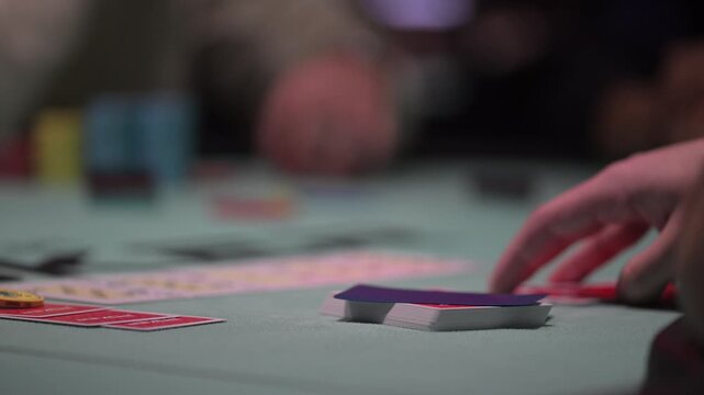 Close up view of two cards during a Texas hold 'Em poker game with defocused background