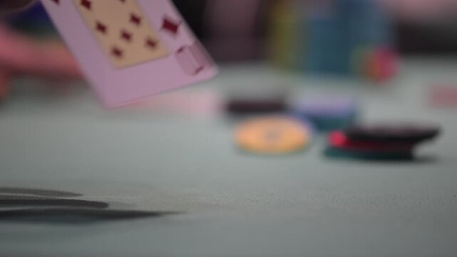 Close up view of two cards during a Texas hold 'Em poker game with defocused background