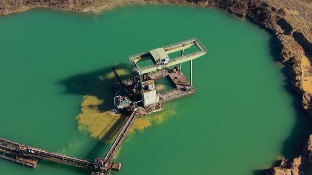 Aerial view of sand dredging machine at work in a quarry lake