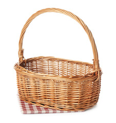 One wicker basket with napkin isolated on white