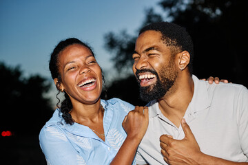 Portrait of a happy young couple, woman and man, black couple having fun laughing talking and bonding going out nightlife party city outdoors