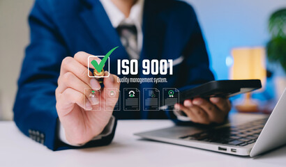 Quality management concept. Businessman approving ISO 9001 quality management system with digital...