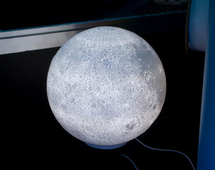Art model lamp Moon printed on 3D printer from molten plastic. Object created on 3D printer. Form printed on 3D printer from blue plastic. Concept 3D printing technology. Additive FDM technologies