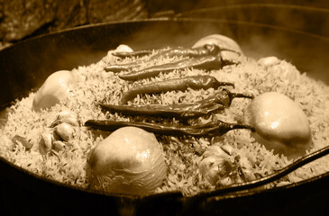Aromatic pilaf is fried in a cauldron