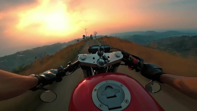 First-person view of a motorcycle rider speeding down a scenic mountain road at sunset.