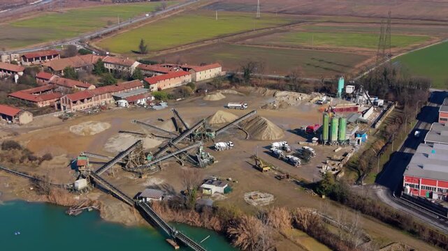 Aerial view of quarry mining with conveyor belts and silos