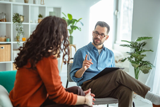 Woman receiving counseling from a male therapist in office