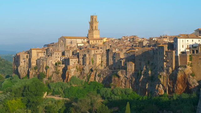 Pitigliano village panoramic view during sunset in tuscany, italy. Stunning morning light illuminating the ancient town of pitigliano, a medieval village perched on a tuff rock cliff