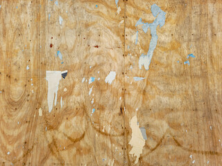 Weathered plywood texture background with torn paper and grunge wood grain
