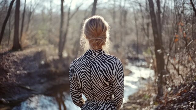 Woman in Zebra Print Gazing at Riverbank