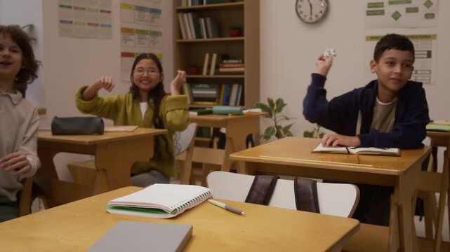 Medium shot of young girl crying and running away while getting bullied in school with children throwing paper at her, laughing