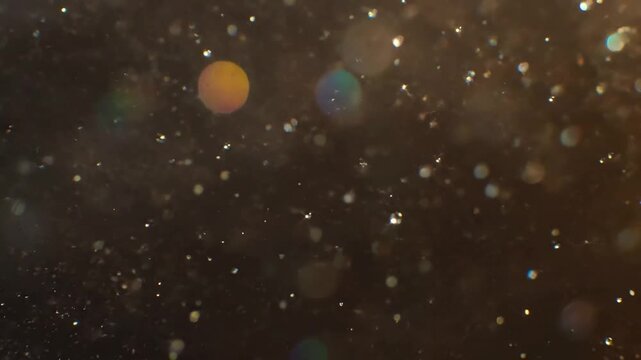 Glistening Micro-Universe Countless tiny, shimmering particles gracefully drifting and interacting, each catching brilliant specular highlights in a vast abstract space.