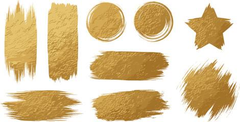 Collection of golden powder brush strokes and shapes on a clean white surface viewed from directly above