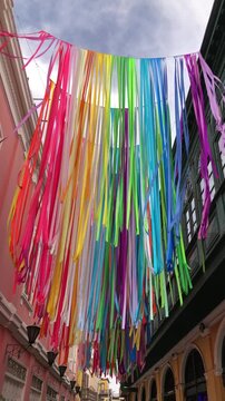 Festive decorations adorn historic Callao street. Vivid festival decorations drape over old Callao street scene