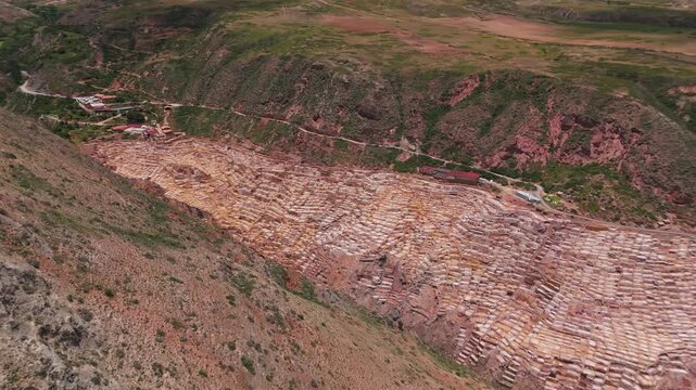 Aerial view of Maras Salt Mines, Peru, with surrounding mountains