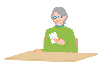 Senior woman checking a postcard