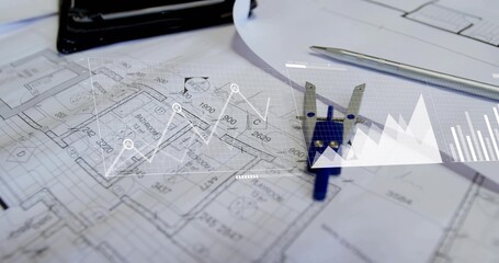 Displaying floor plans with blue caliper and pen on design desk, overlaid digital charts