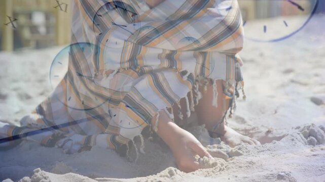 Girl kneeling, digging sand, camera pulling back, girl adjusting wrap, clock over girl for health