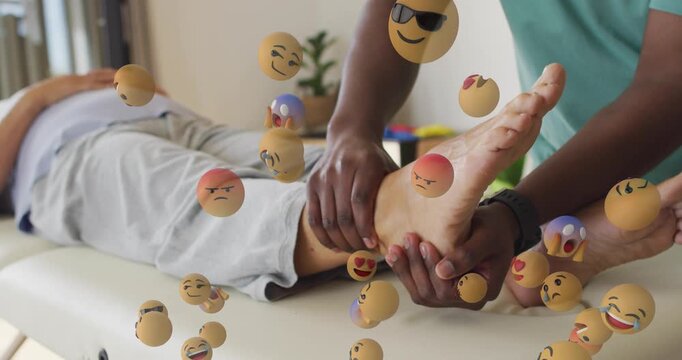 Therapist moving patient ankle and foot, causing emojis around foot assessing mobility in therapy