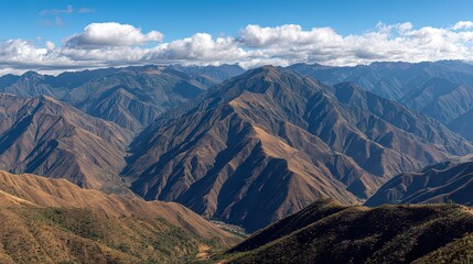 Scenic Mountain Range Under Partially Cloudy Sky View with Brown Vegetation and Rugged Terrain in Daylight