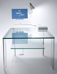 Modern office setup with glass desk, monitor, lamp, and diagrams