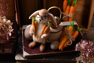 Easter decoration with handicraft felted bunny and carrots