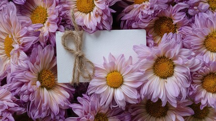 Greeting Card Surrounded by Fresh Purple and Yellow Chrysanthemum Flowers with Water Droplets and Natural Twine in an Overhead View